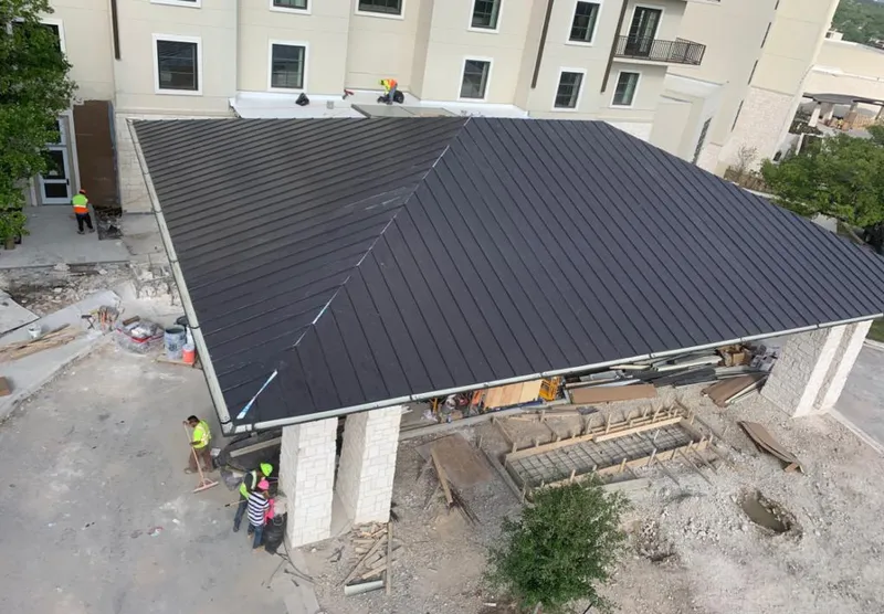 Metal roofing installation team working on a commercial building in Columbia